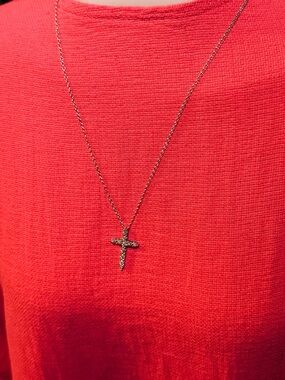 White gold necklace and diamond cross charm.